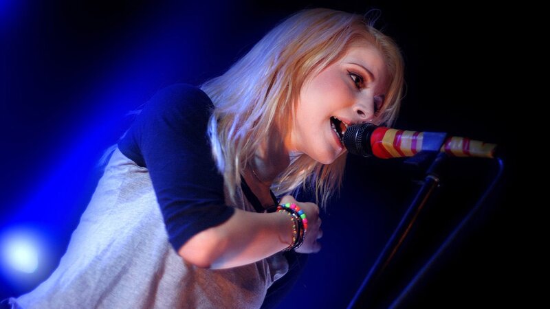 Woman Singing into Microphone — Blue, Dramatic, Night, Photograph, Stage Light, Bracelet, Black, White