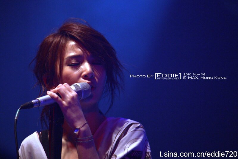 Woman Singing into Microphone — Blue, Dramatic, Night, Photograph, Stage Light, Bracelet, Purple