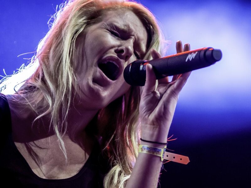 Woman Singing into Microphone — Blue, Intense, Photograph