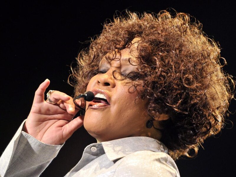 Woman Singing into Microphone — Brown, Dramatic, Photograph, Curly Hair