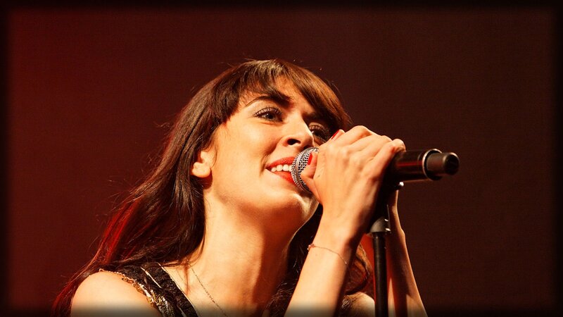 Woman Singing into Microphone — Red, Dramatic, Photograph