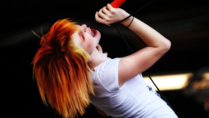 Woman Singing into Microphone — Red, Dramatic, Photograph, White T-shirt