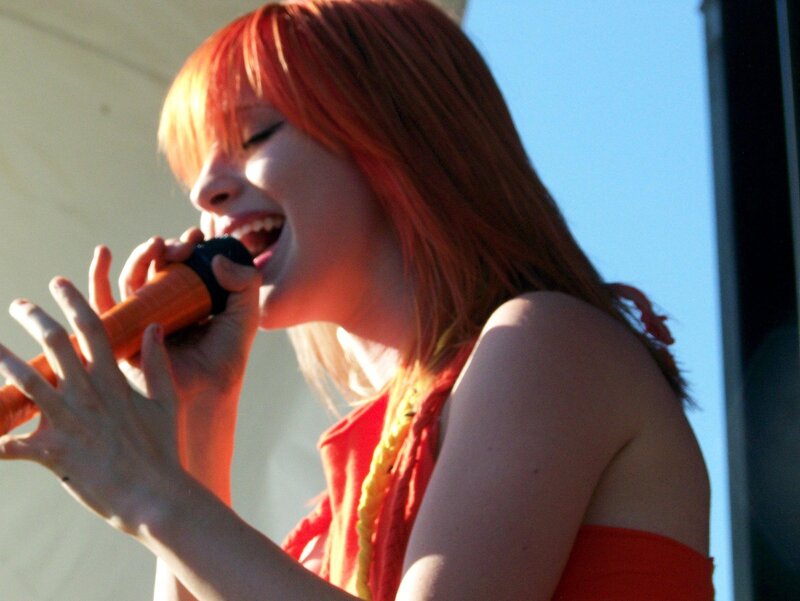 Woman Singing into Microphone — Red, Energetic, Afternoon