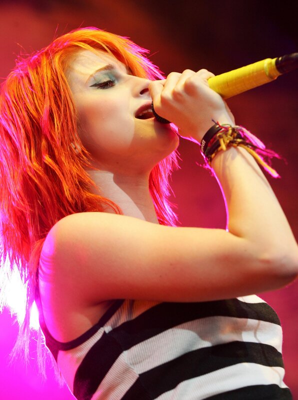 Woman Singing into Microphone — Red, Energetic, Photograph