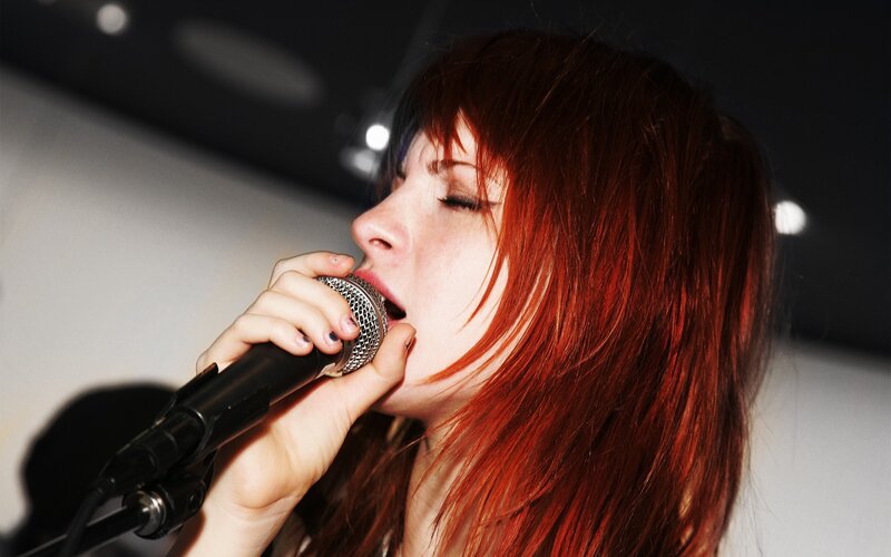 Woman Singing into Microphone — Red, Intense, Night, Photograph