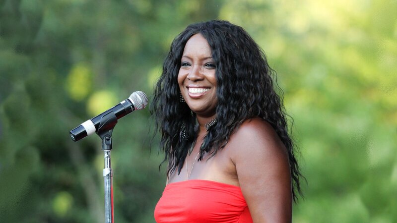 Woman Singing into Microphone — Red, Outdoor