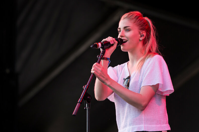 Woman Singing into Microphone — White, Energetic, Night