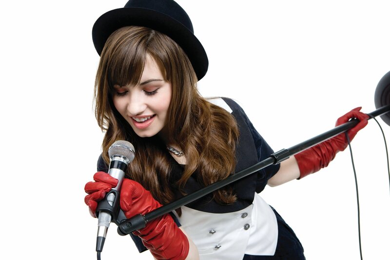 Woman Singing into Microphone — White, Energetic, Photograph, Hat