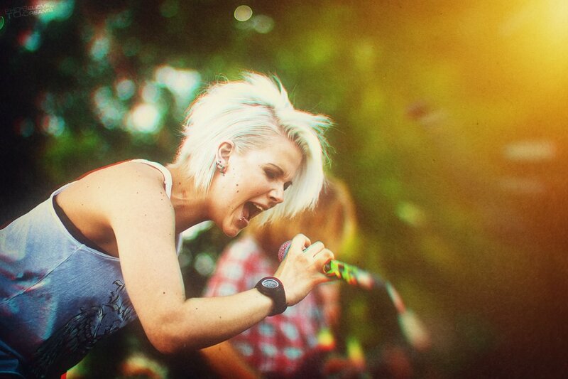Woman Singing into Microphone — White, Energetic, Sunset