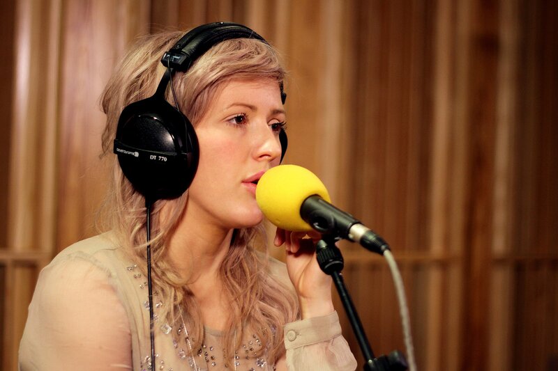 Woman Singing into Microphone — Yellow, Focused