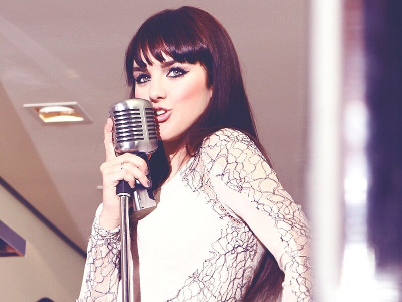 woman singing into vintage microphone