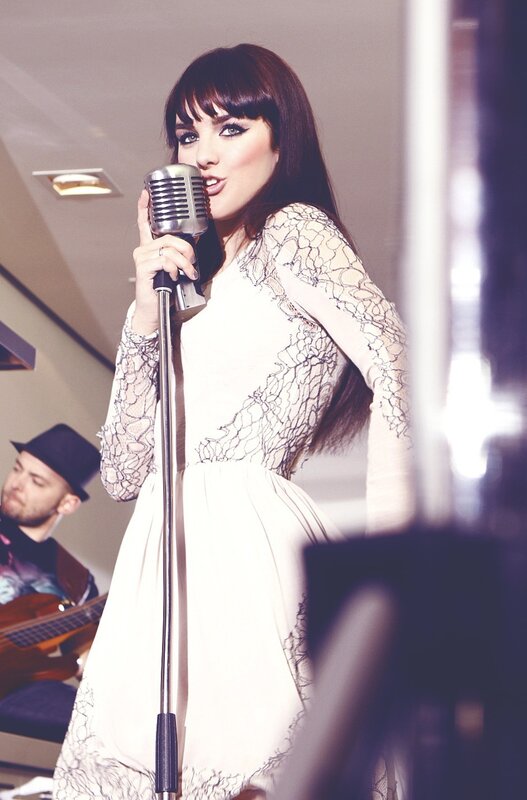 woman singing into vintage microphone