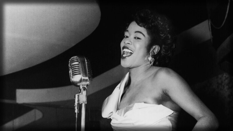 woman singing into vintage microphone