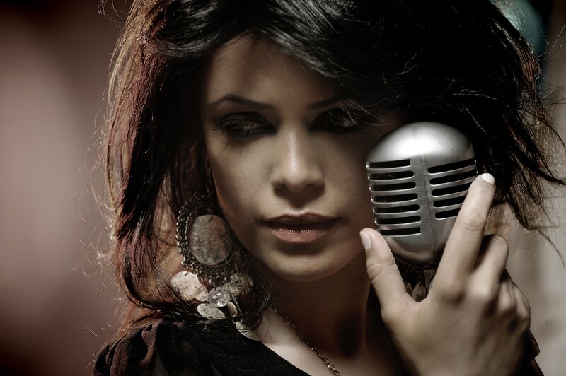 woman singing into vintage microphone