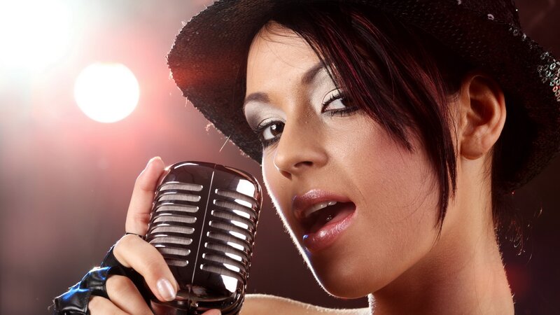 woman singing into vintage microphone