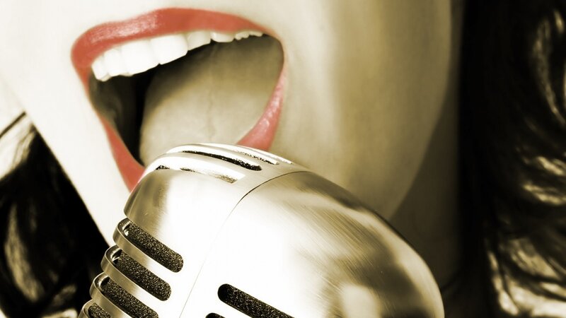 woman singing into vintage microphone