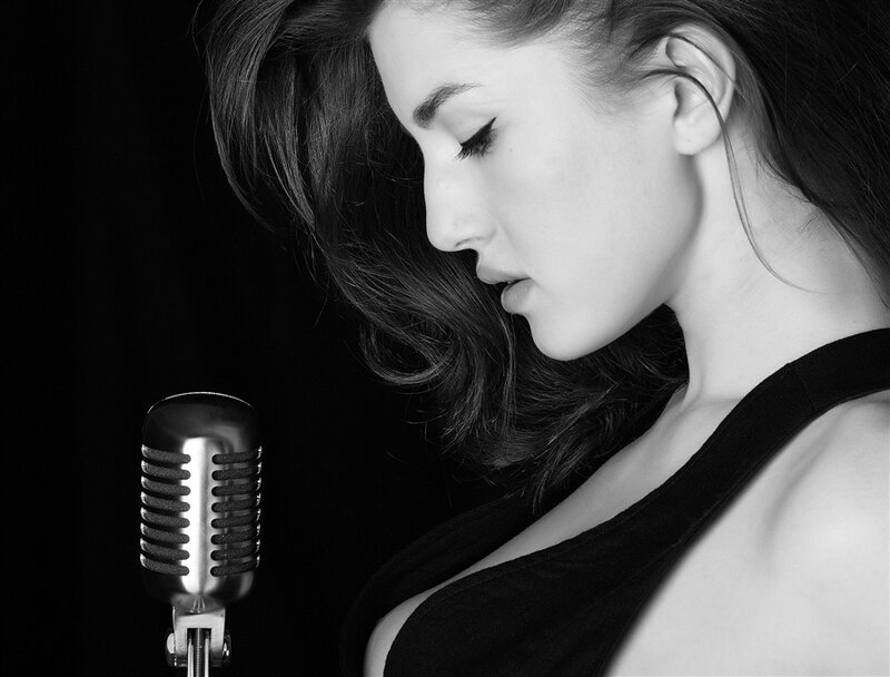 woman singing into vintage microphone