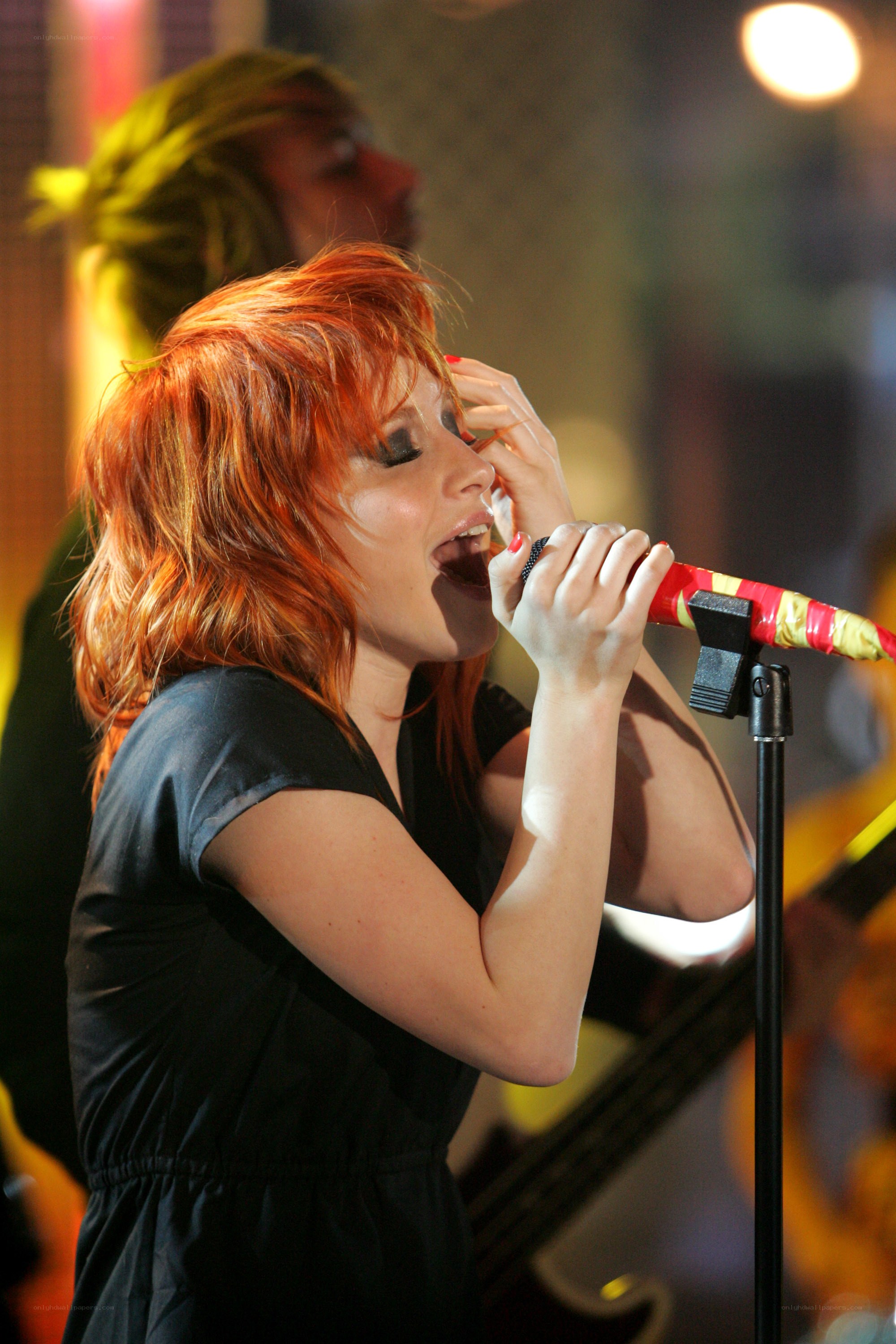 woman singing on stage