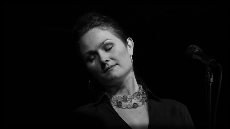 woman singing on stage