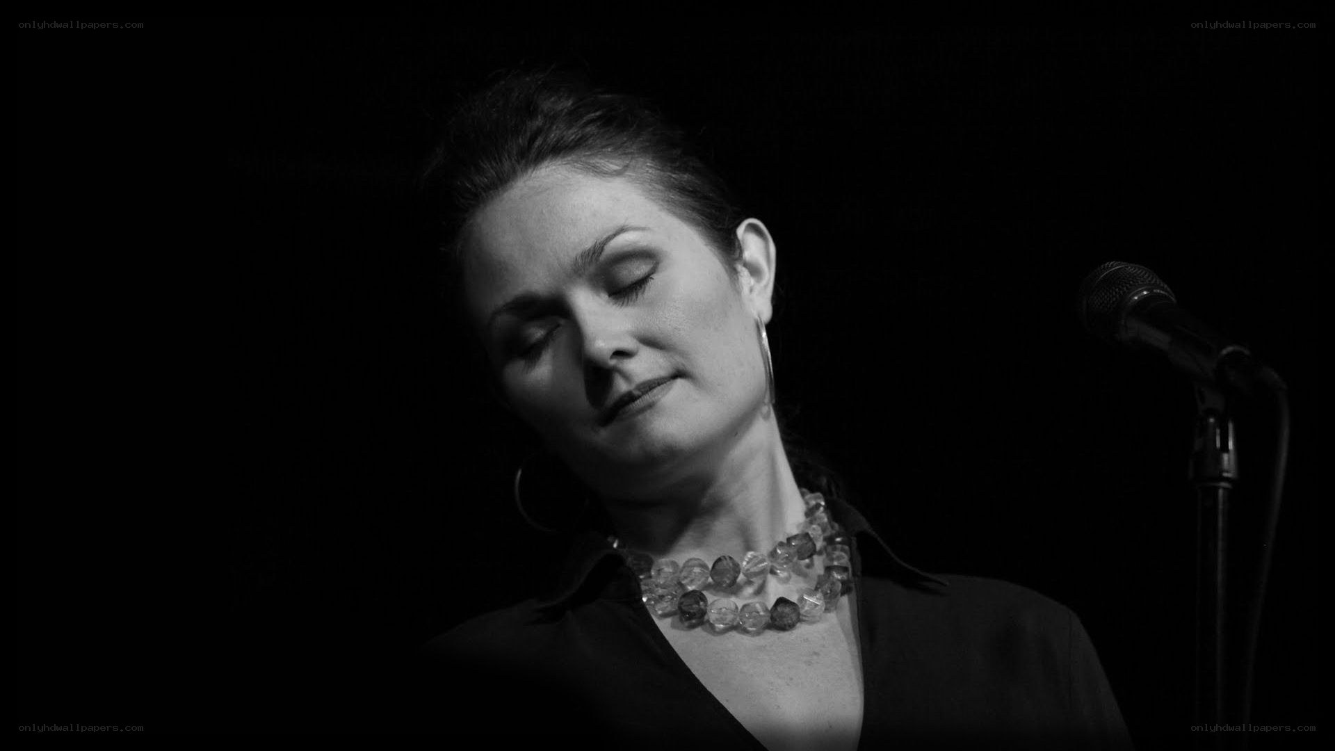 woman singing on stage