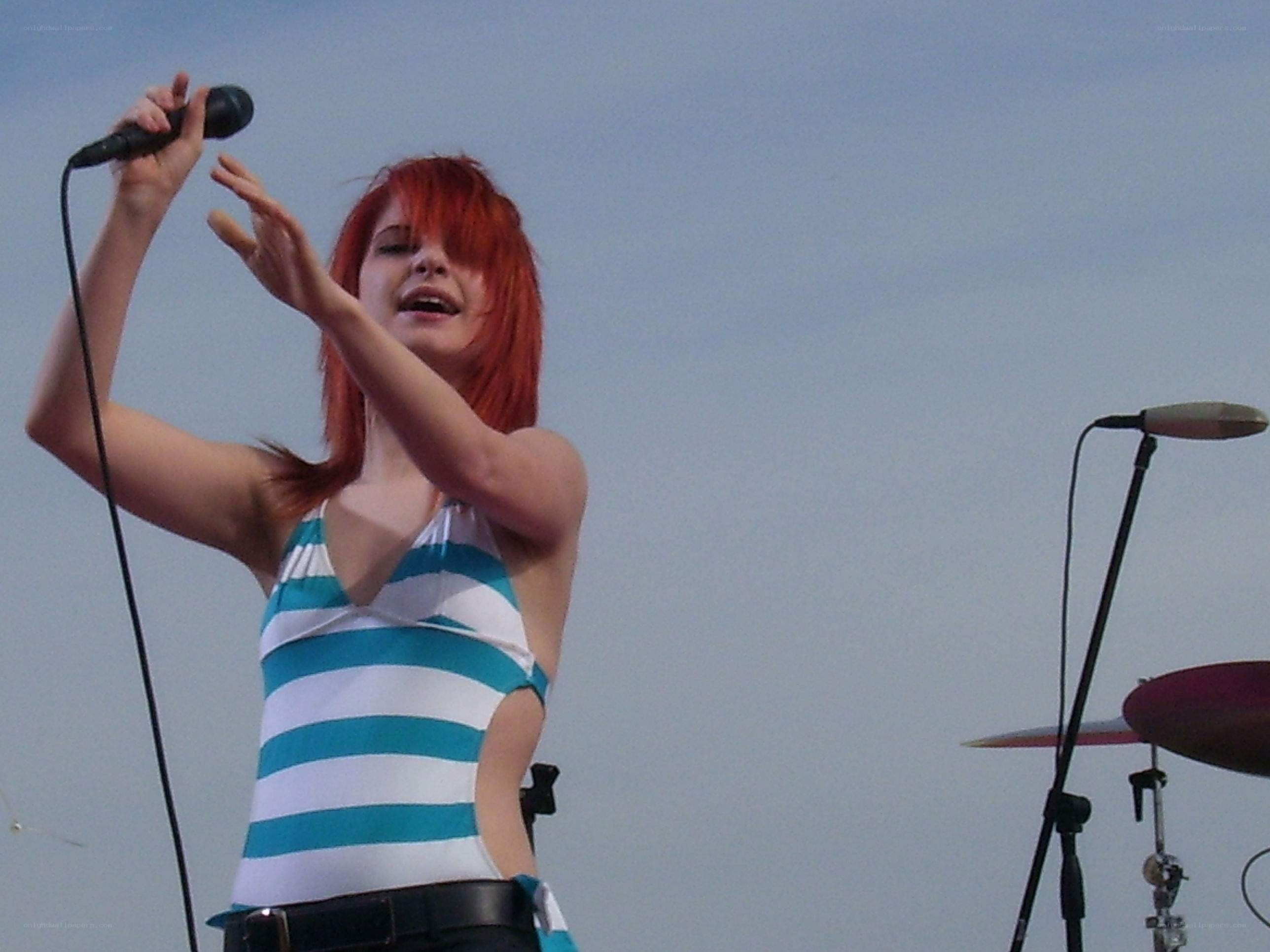 woman singing on stage