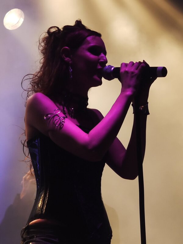 woman singing on stage