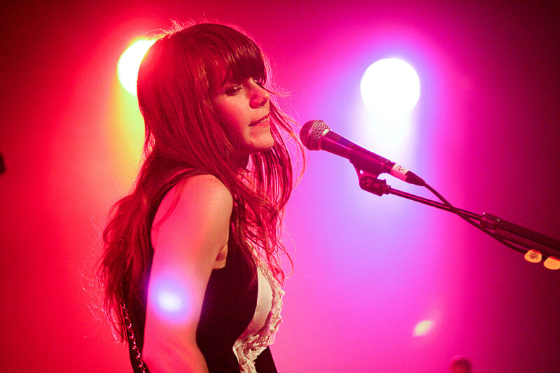 woman singing on stage