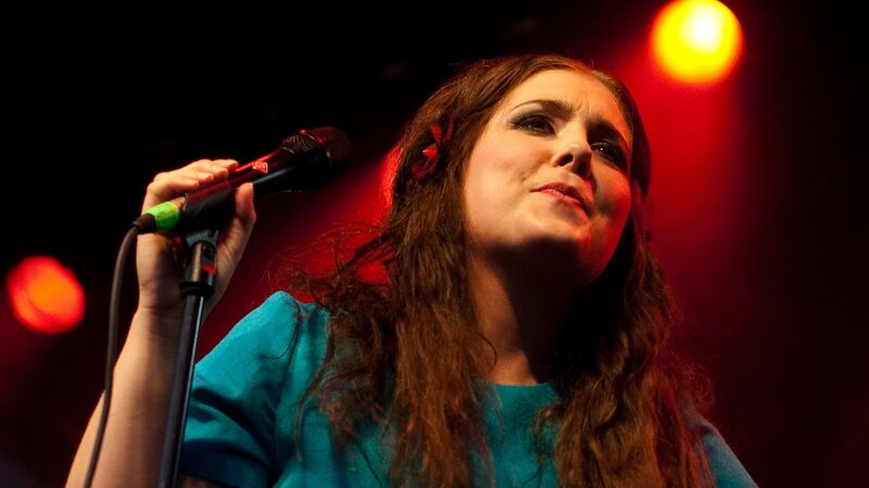woman singing on stage