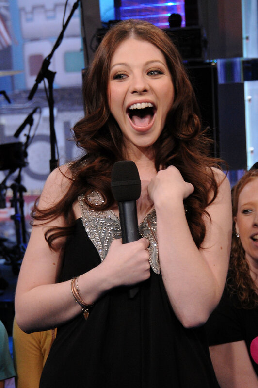 woman singing on stage
