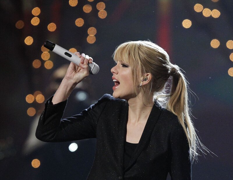 woman singing on stage
