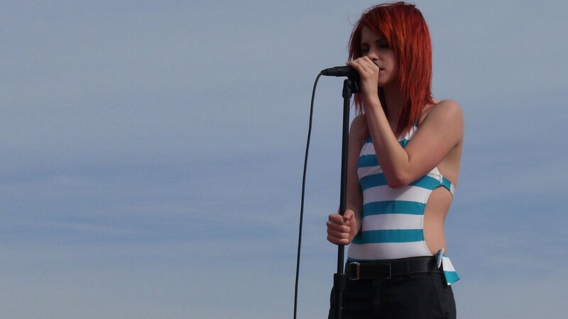 woman singing on stage