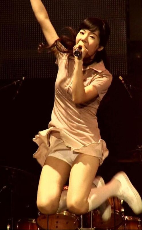 woman singing on stage