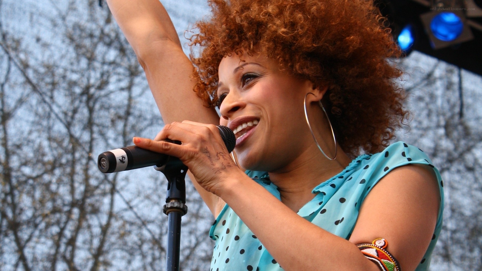 woman singing on stage