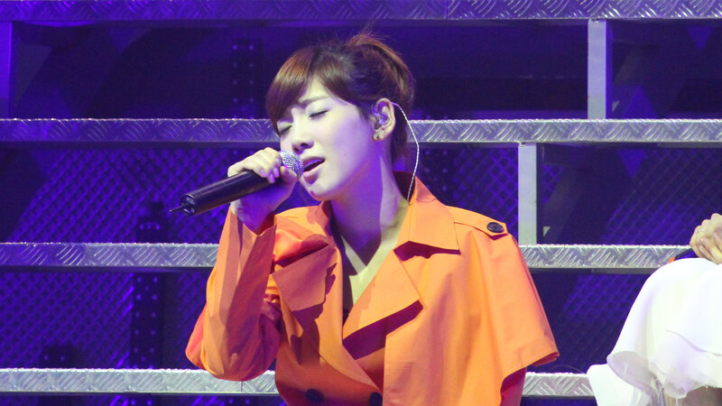woman singing on stage