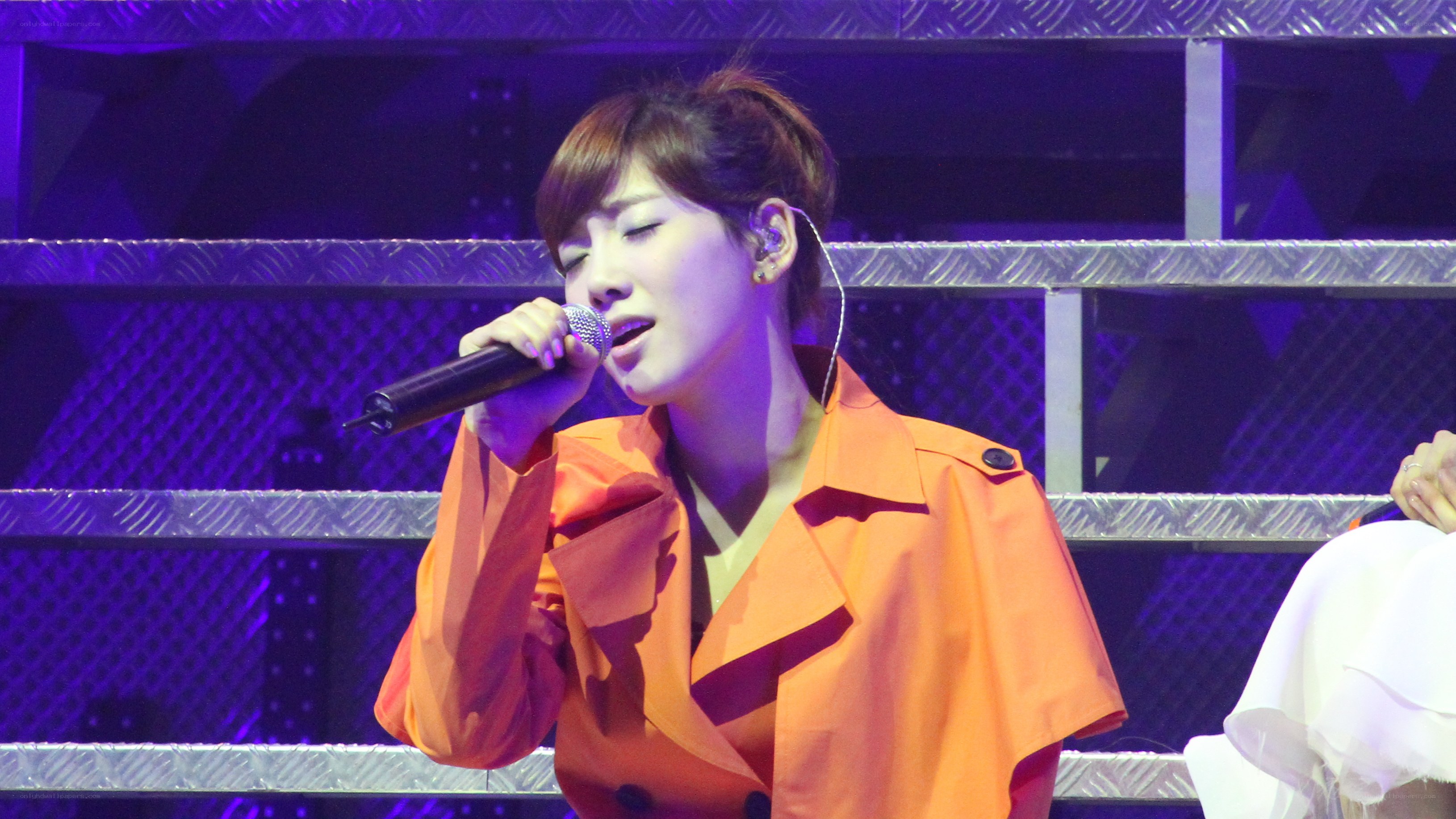 woman singing on stage