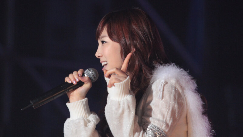 woman singing on stage