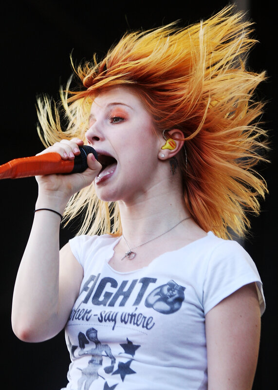 woman singing on stage