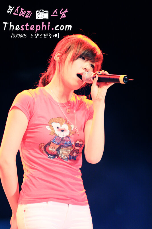 woman singing on stage