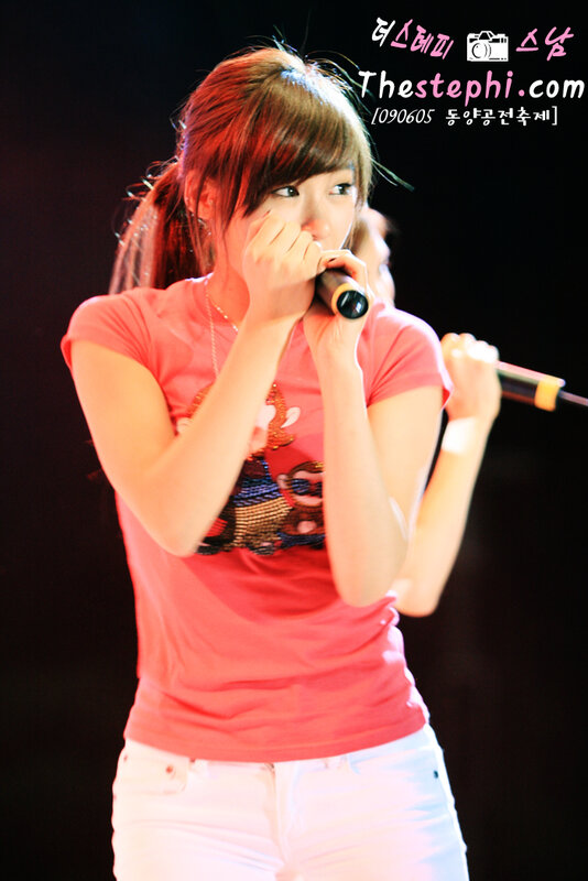 woman singing on stage