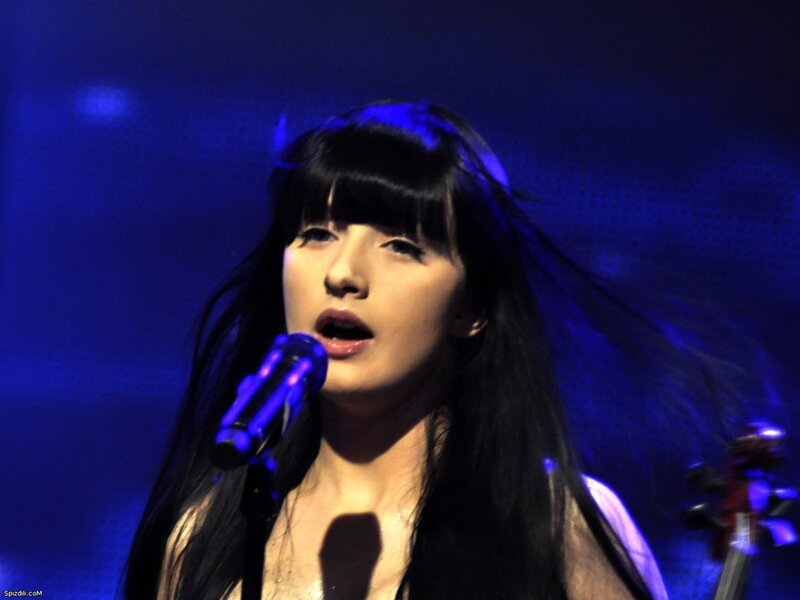 woman singing on stage