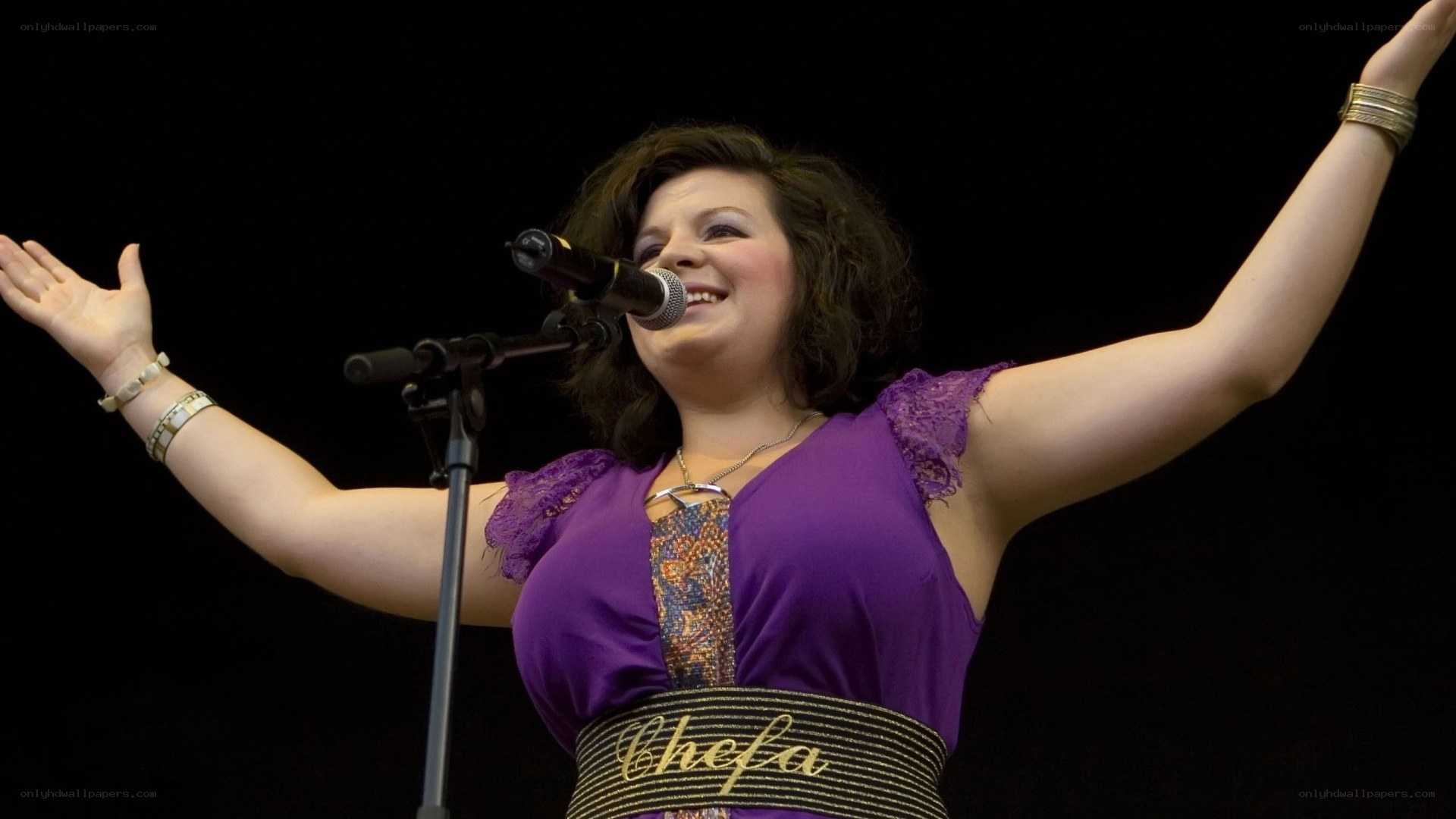 woman singing on stage