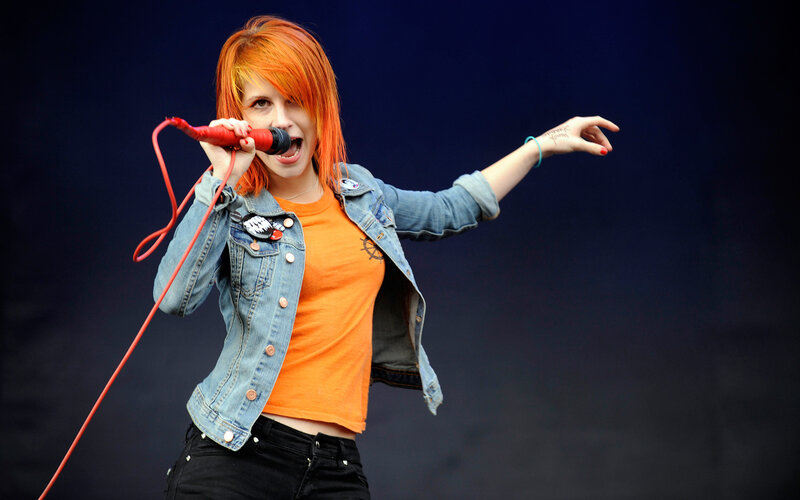 woman singing on stage