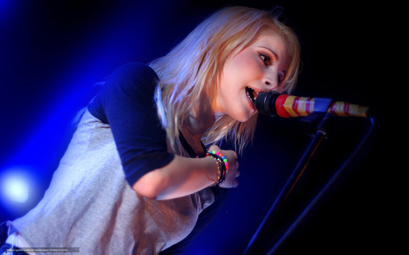 woman singing on stage