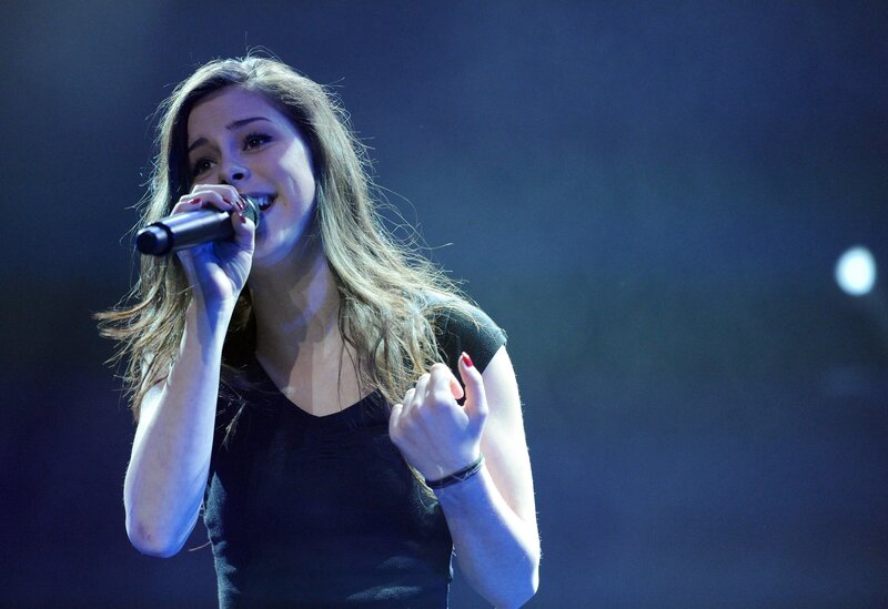woman singing on stage