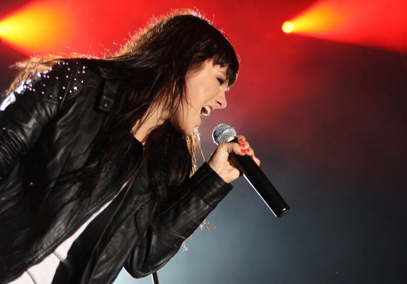 woman singing on stage