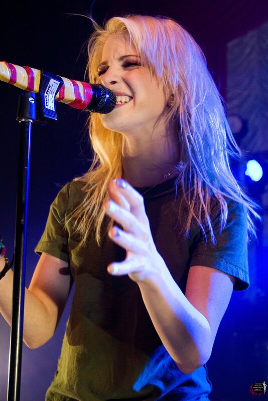woman singing on stage