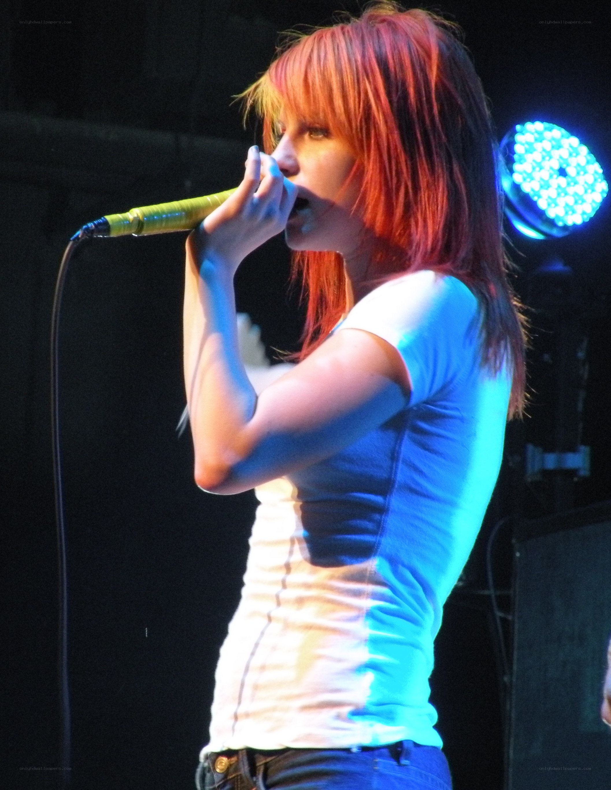 woman singing on stage