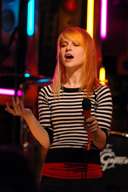 woman singing on stage