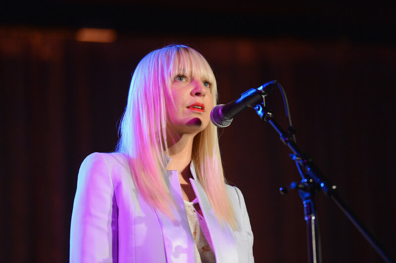 woman singing on stage