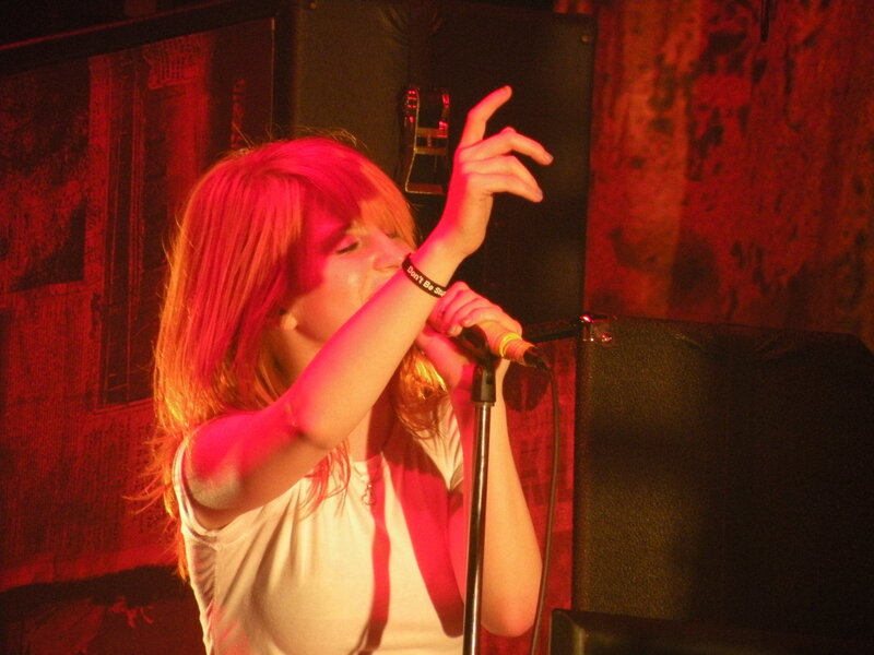 woman singing on stage